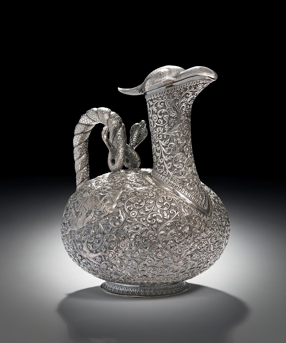 Lot 209: A FINE REPOUSSE SILVER CLARET JUG POSSIBLY BY OOMERSI MAWJI, INDIA, CIRCA 1890