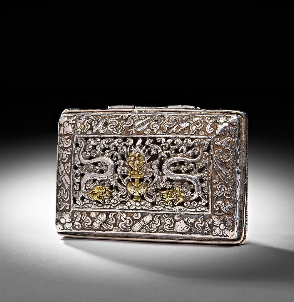 Lot 215: A CARVED GILT SILVER RECTANGULAR COVERED BOX, POSSIBLY TIBETAN, 20TH CENTURY