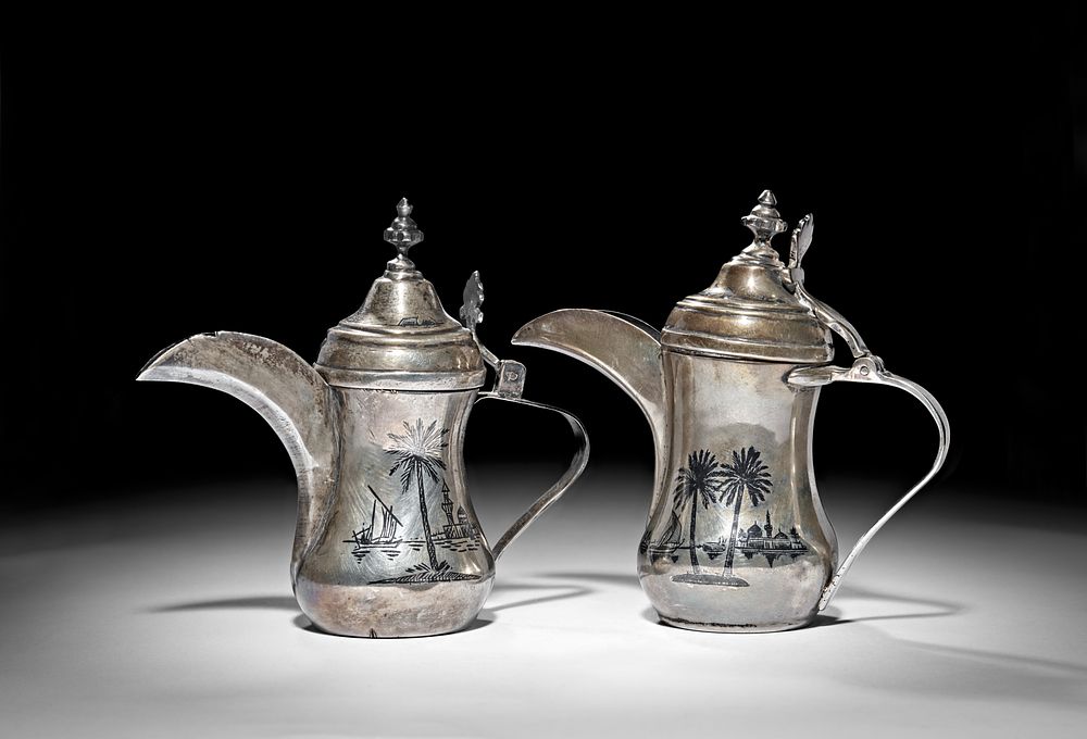 Lot 237: TWO IRAQI SILVER AND NIELLO COFFEE POT (DALLAH), 20TH CENTURY