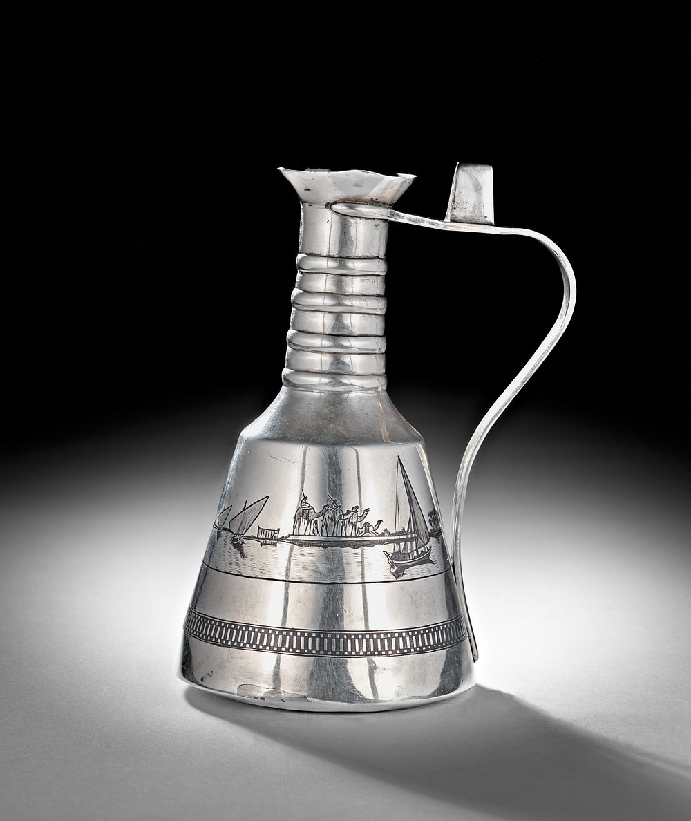 Lot 243:  AN IRAQI SILVER AND NIELLO WATER EWER, BASRA, 20TH CENTURY
