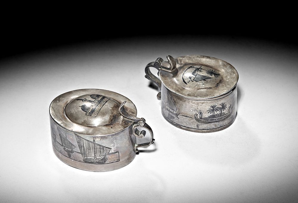 Lot 244: TWO IRAQI SILVER AND NIELLO MUSTARD POTS, 20TH CENTURY