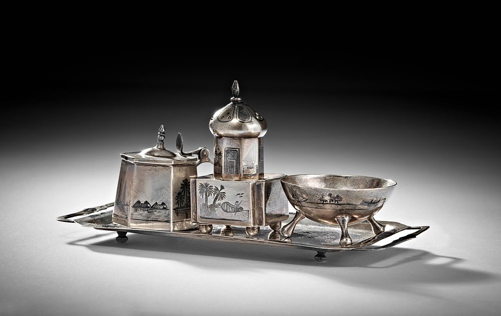 Lot 247: A 20TH CENTURY IRAQI SILVER AND NIELLO CRUET ON TRAY