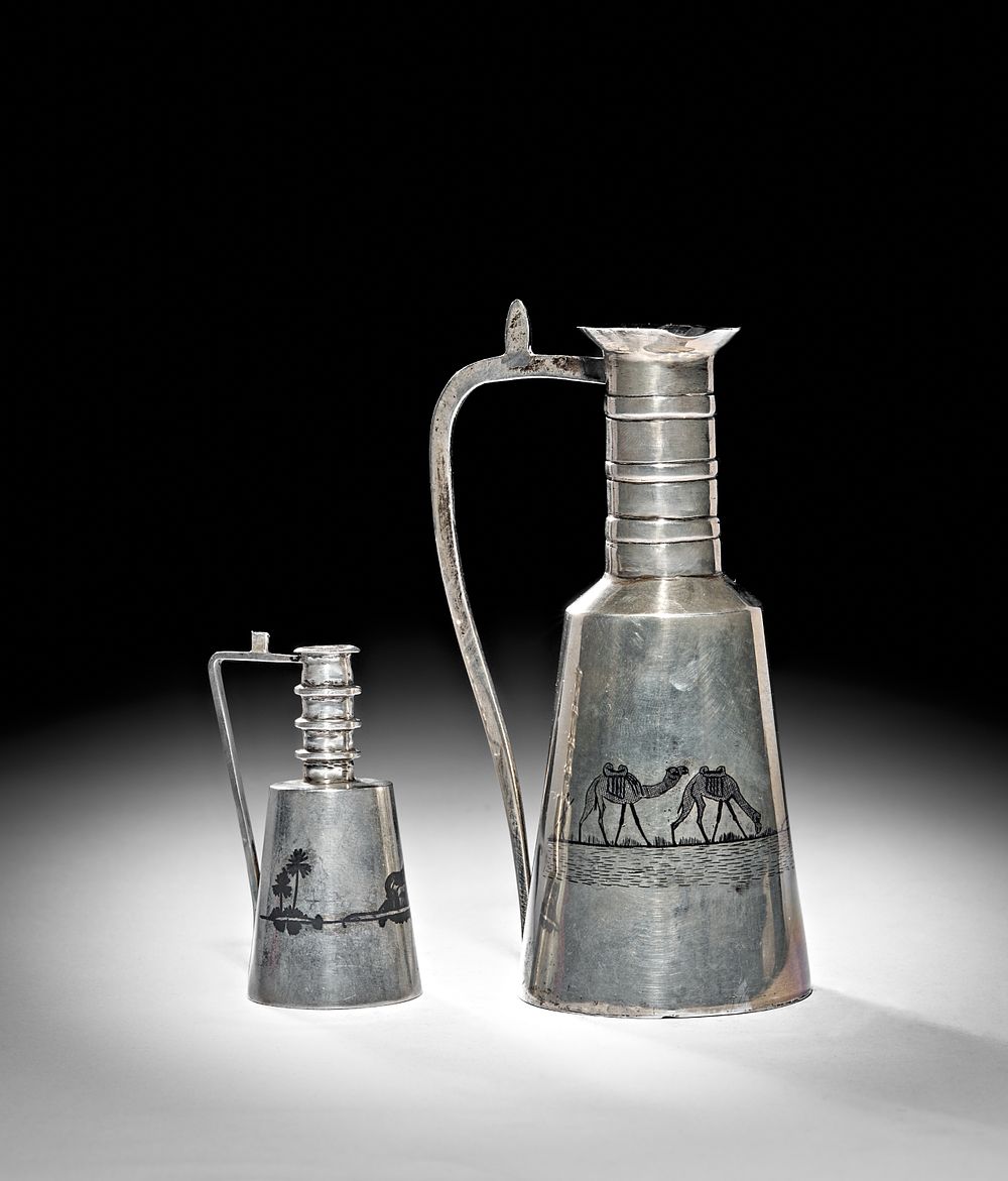 Lot 249: TWO IRAQI SILVER AND NIELLO WATER EWERS, BASRA, 20TH CENTURY