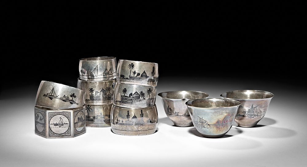 Lot 250: A GROUP OF IRAQI SILVER AND NIELLO NAPKIN RINGS AND COFFEE CUPS, 20TH CENTURY
