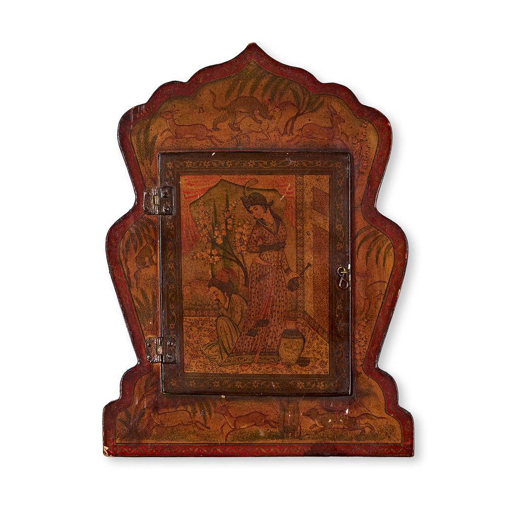 Lot 159: A QAJAR LACQUERED PAPIER MACHE MIRROR CASE IN A MIHRAB SHAPE, EARLY 20TH CENTURY 