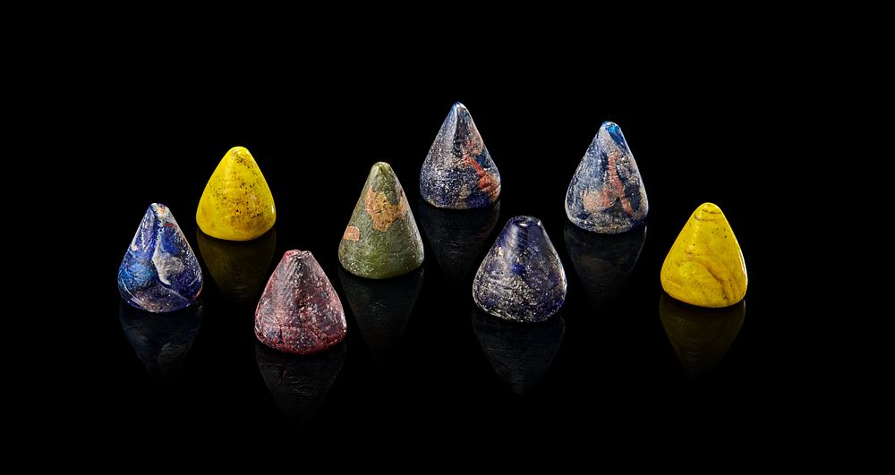 Lot 173: A COLLECTION OF EIGHT POSSIBLY EARLY ISLAMIC GLASS GAMING PIECES