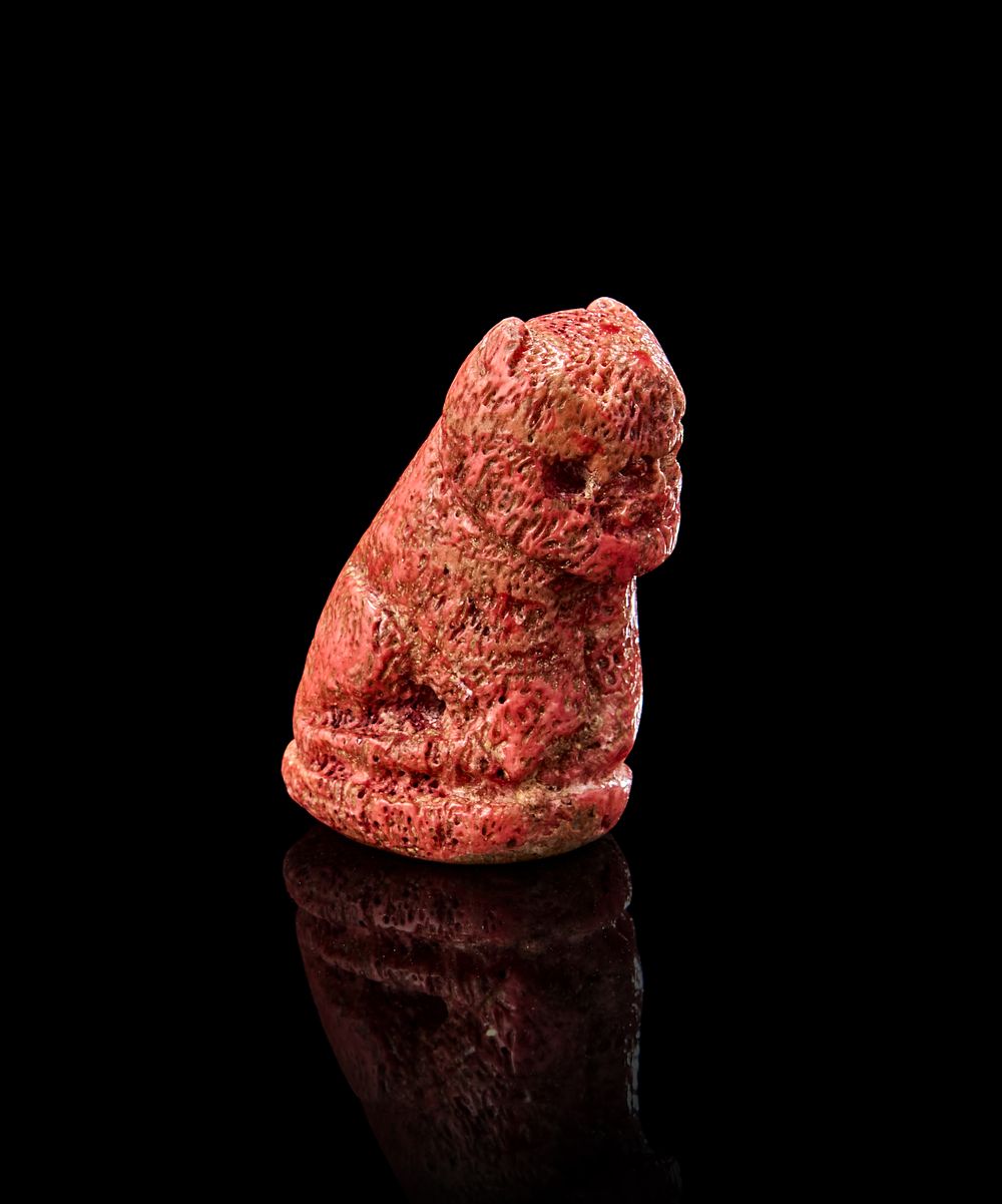 Lot 175: A RARE EARLY ISLAMIC CARVED LION SHAPED GAMING PIECE, POSSIBLY CORAL