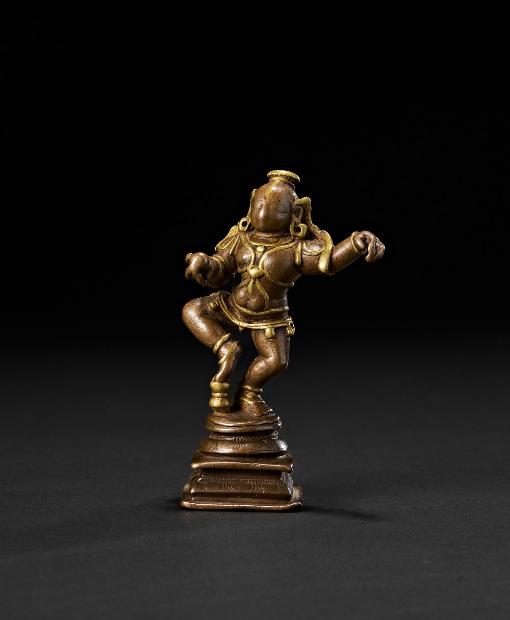 Lot 194: A RARE SOUTH INDIAN TANJORE BRASS INLAID BRONZE FIGURE OF KRISHNA, 18TH CENTURY