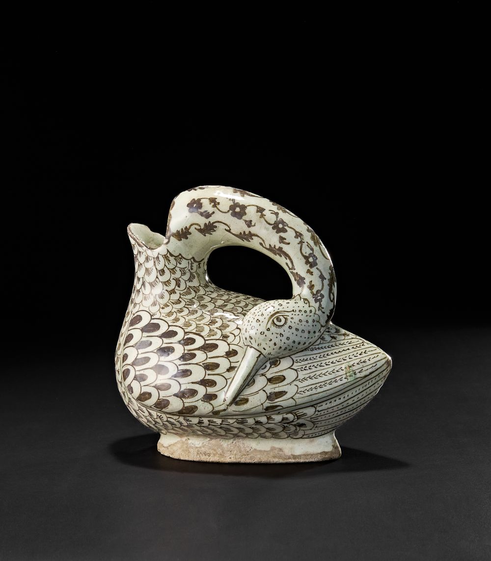 Lot 204: AN UNUSUAL QAJAR POTTERY DUCK SHAPED JUG, EARLY 20TH CENTURY