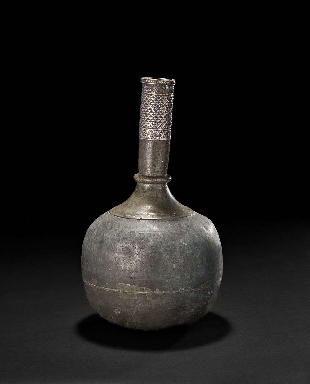 Lot 206: A MUGHAL SILVER MOUNTED LEAD SURAHI BOTTLE, INDIA, 18TH CENTURY