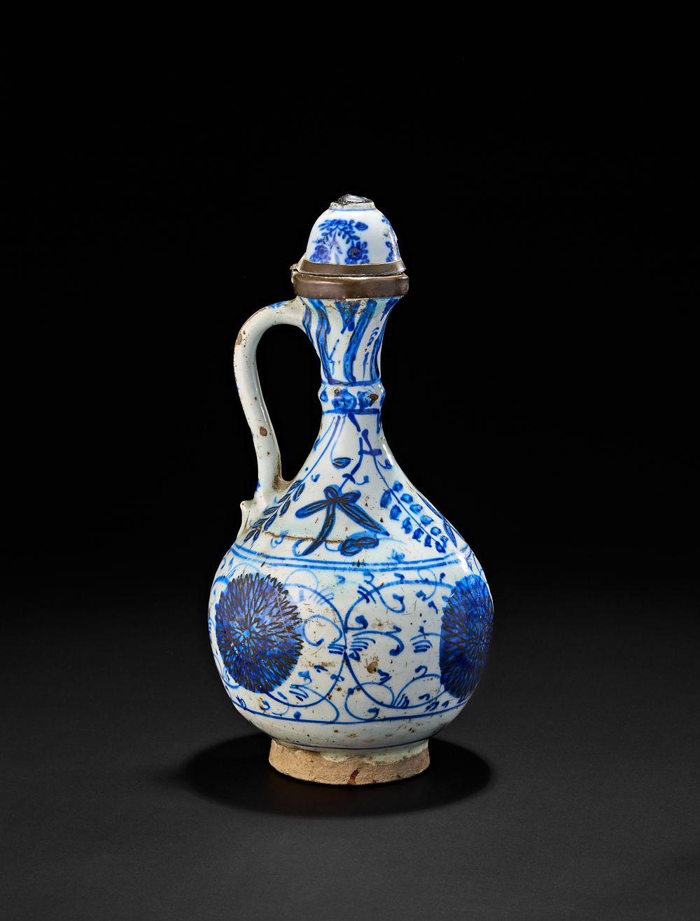 Lot 228: AN OTTOMAN IZNIK POTTERY GLAZED JUG, TURKEY, 17TH CENTURY