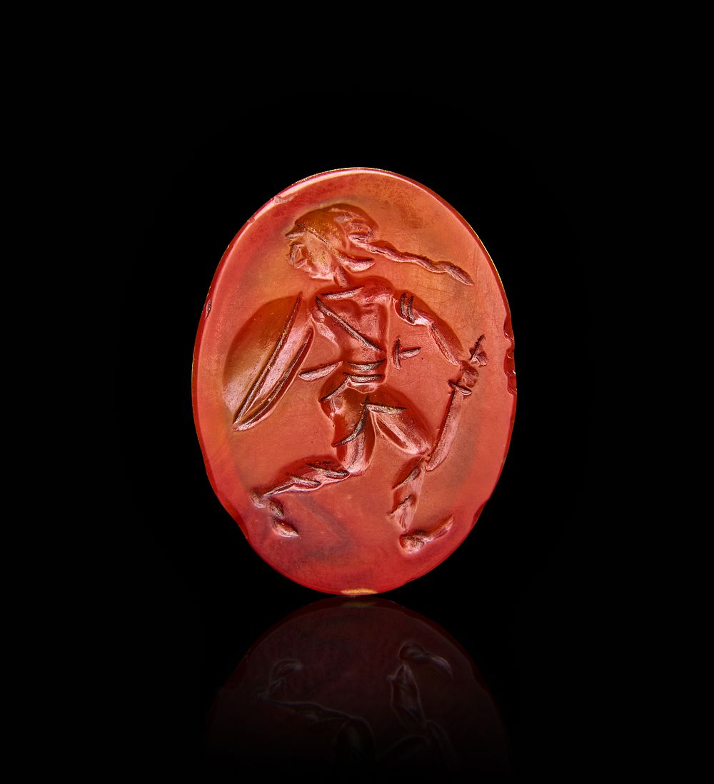 A RED ROMAN AGATE INTAGLIO DEPICTING A WARRIOR, 1ST - 2ND CENTURY A.D 
L: 2.1cm