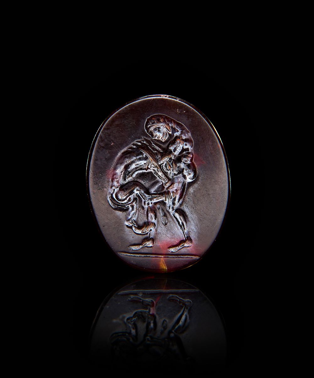 A ROMAN GARNET INTAGLIO OF HERCULES CHALLENGING A LION, 1ST - 2ND CENTURY A.D 
L: 2cm