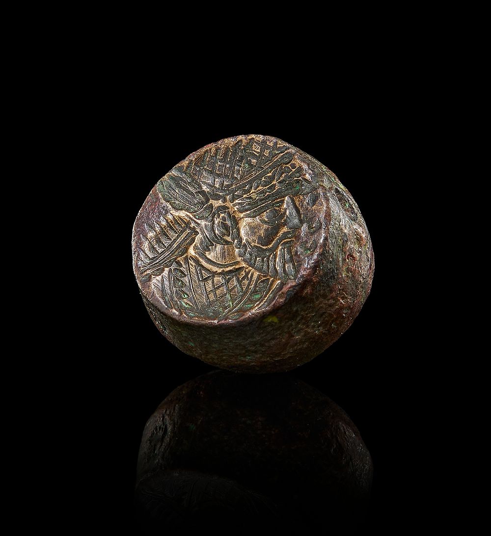 A SASANIAN BRONZE STAMP BEARING A BUST OF A DIGNITARY 
2cm Diameter