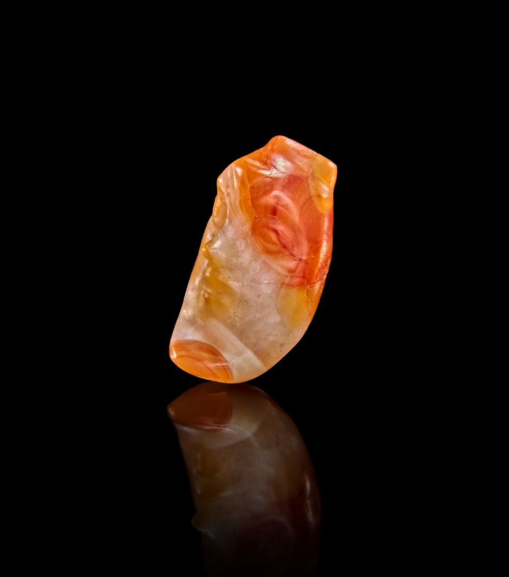 Lot 78: A THEATRICAL ROMAN AGATE PENDANT THE FORM OF A FACE, 1ST - 2ND CENTURY A.D.