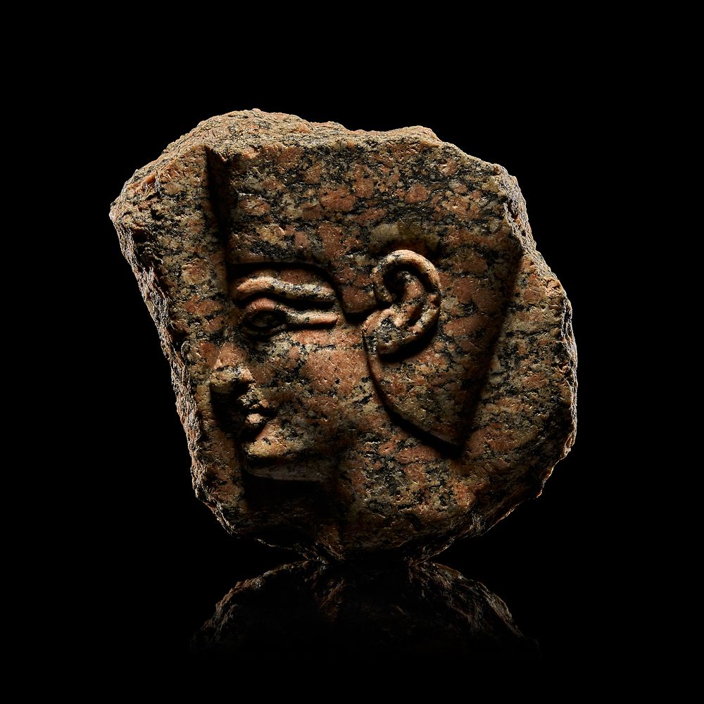 Lot 101: AN EGYPTIAN RED STONE DEPICTS A KING OR A RULER WEARING A HEDJET, MIDDLE KINGDOM, 1700 - 1400 B.C. OR LATER