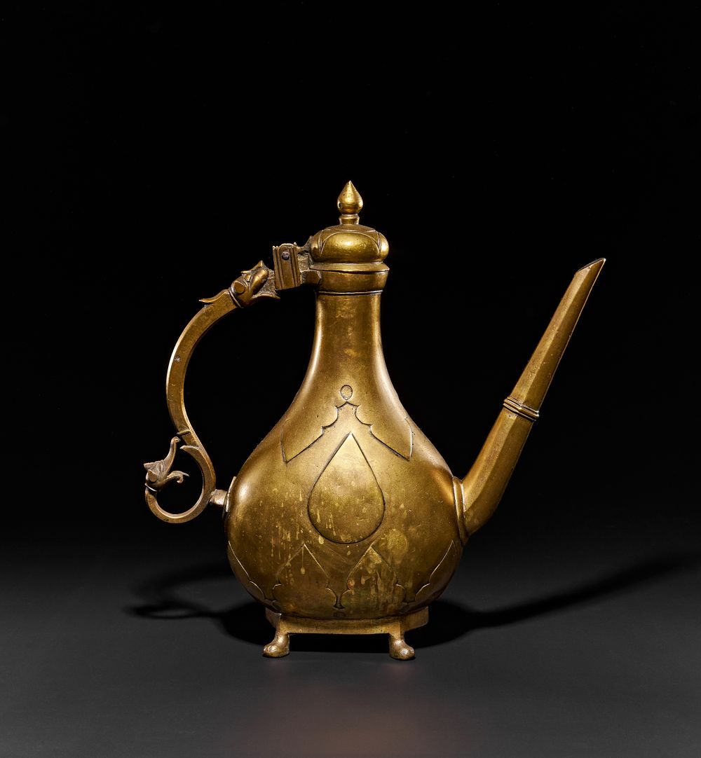 Lot 144: A LARGE BRASS MUGHAL EWER WITH ZOOMORPHIC HANDLE, INDIA, 18TH CENTURY