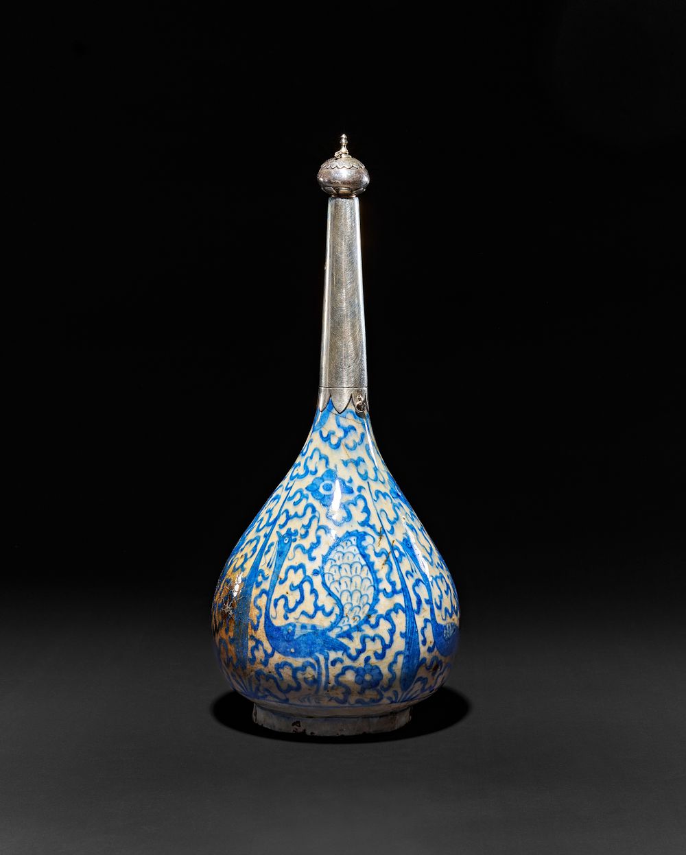 Lot 265: A BLUE AND WHITE SAFAVID GLAZED POTTERY SURAHI BOTTLE, PERSIA, 16TH - 17TH CENTURY