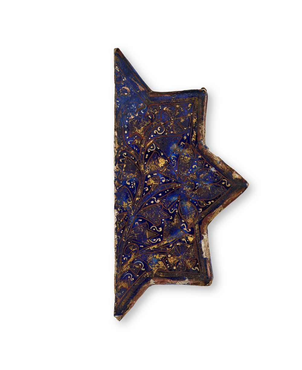 Lot 329: A HALF STAR SHAPE BLUE LAJVARDINA MOULDED POTTERY TILE, PERSIA, 12TH - 13TH CENTURY