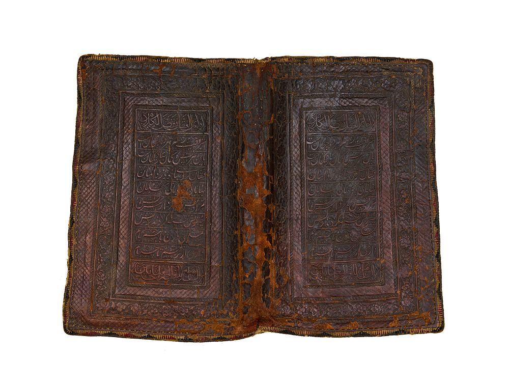 Lot 256: A LEATHER QAJAR BOOK COVER WITH CALLIGRAPHY, 19TH CENTURY