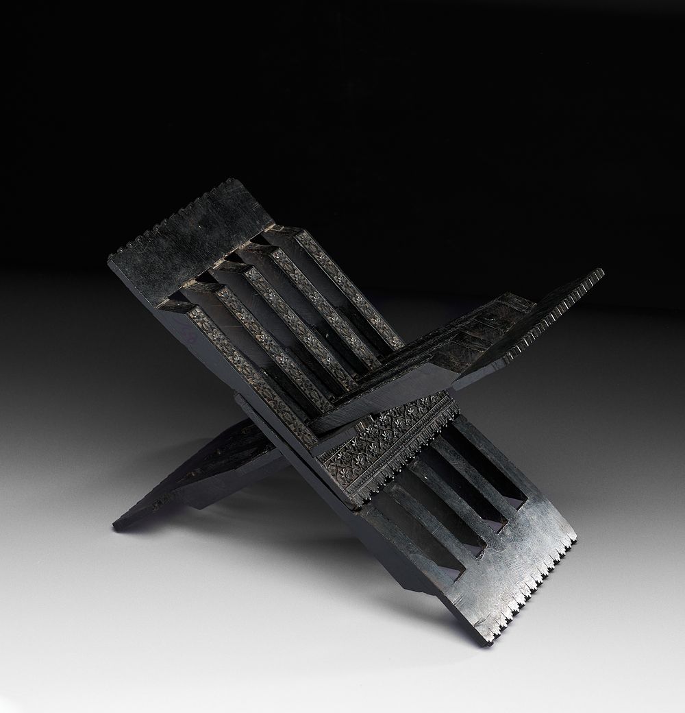 Lot 168: A CARVED NORTH INDIAN EBONY TABLE QURAN STAND, 19TH CENTURY