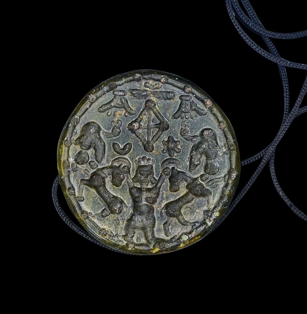 Lot 228: A ROUND JADE OR AGATE ACHAEMENID PERIOD AMULET, 559 -330 B.C.