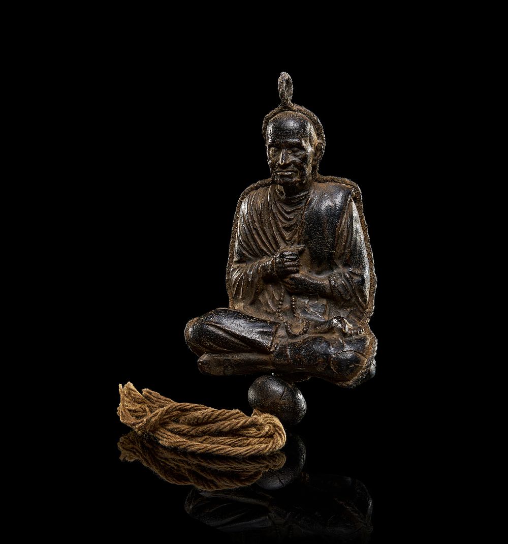 Lot 206: A LEATHER BUDDHIST DEITY OR MONK, POSSIBLY CHINESE, 19TH CENTURY OR EARLIER