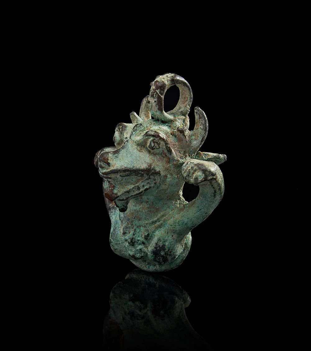 Lot 231: AN ANCIENT BRONZE AMULET IN THE FORM OF A MYTHICAL ANIMAL, LURISTAN