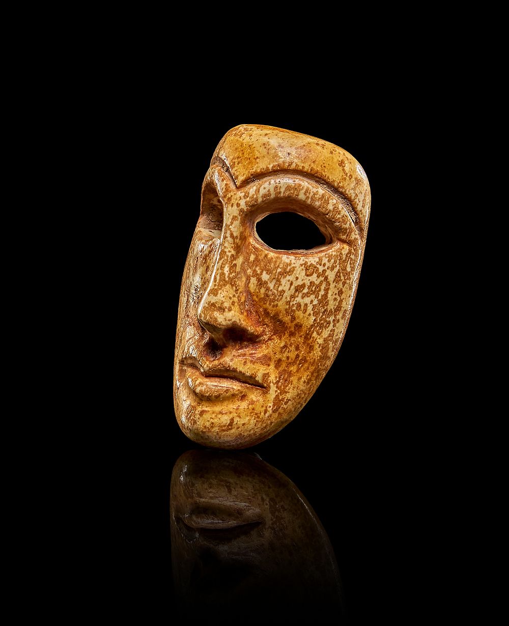Lot 236: A MINIATURE BONE MASK, MARI PERIOD OF ANCIENT MESOPOTAMIA, CIRCA 3RD - 2ND MILLENNIUM B.C.