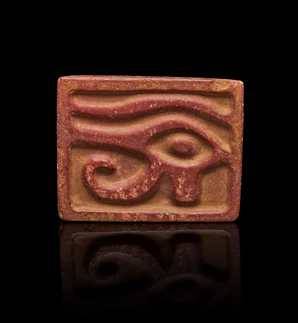 Lot 242: A RED JASPER AMULET IN THE FORM OF EYE OF HORUS, EGYPT, CIRCA 600 - 400 B.C.