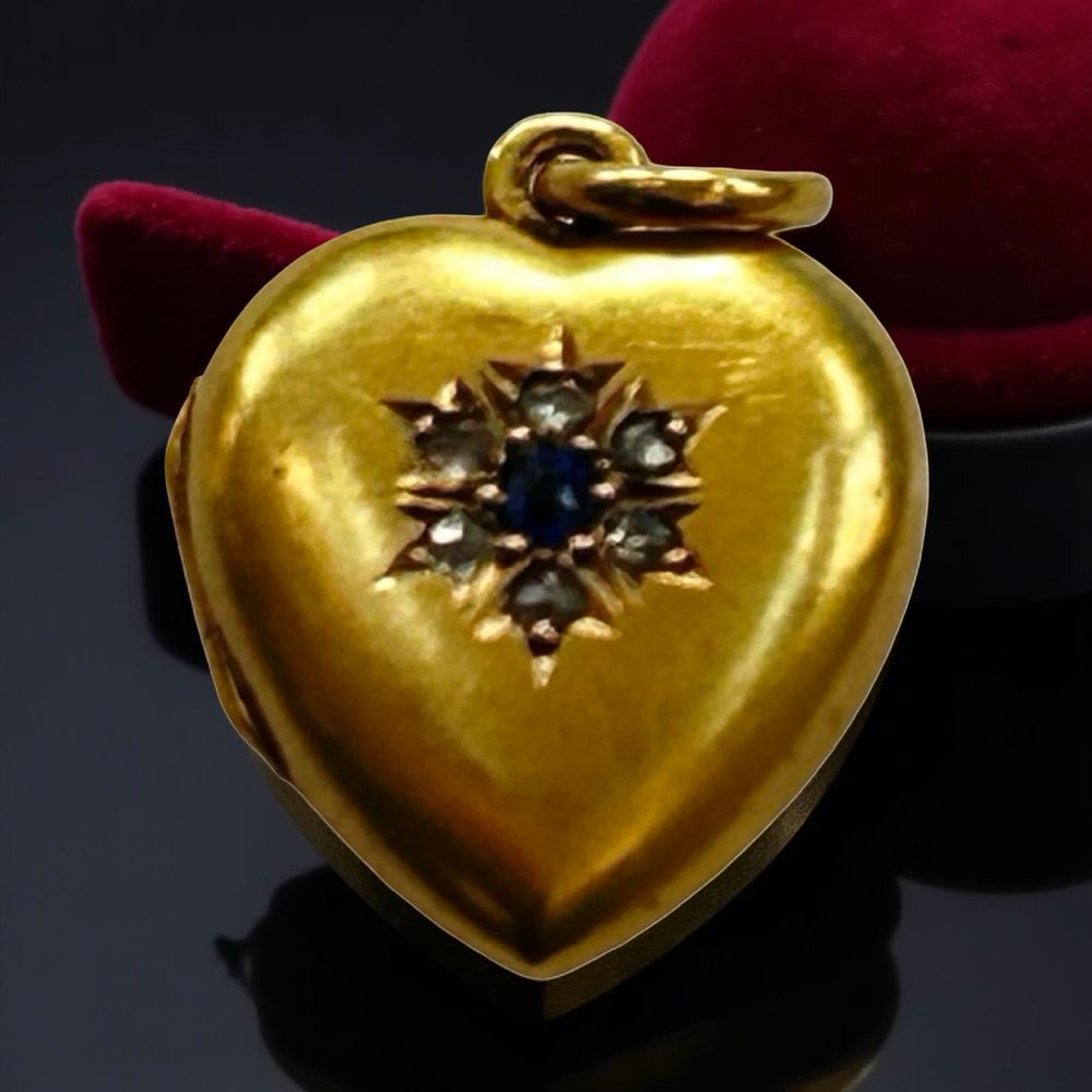 Lot 354: 15ct gold, ruby and diamond heart locket.