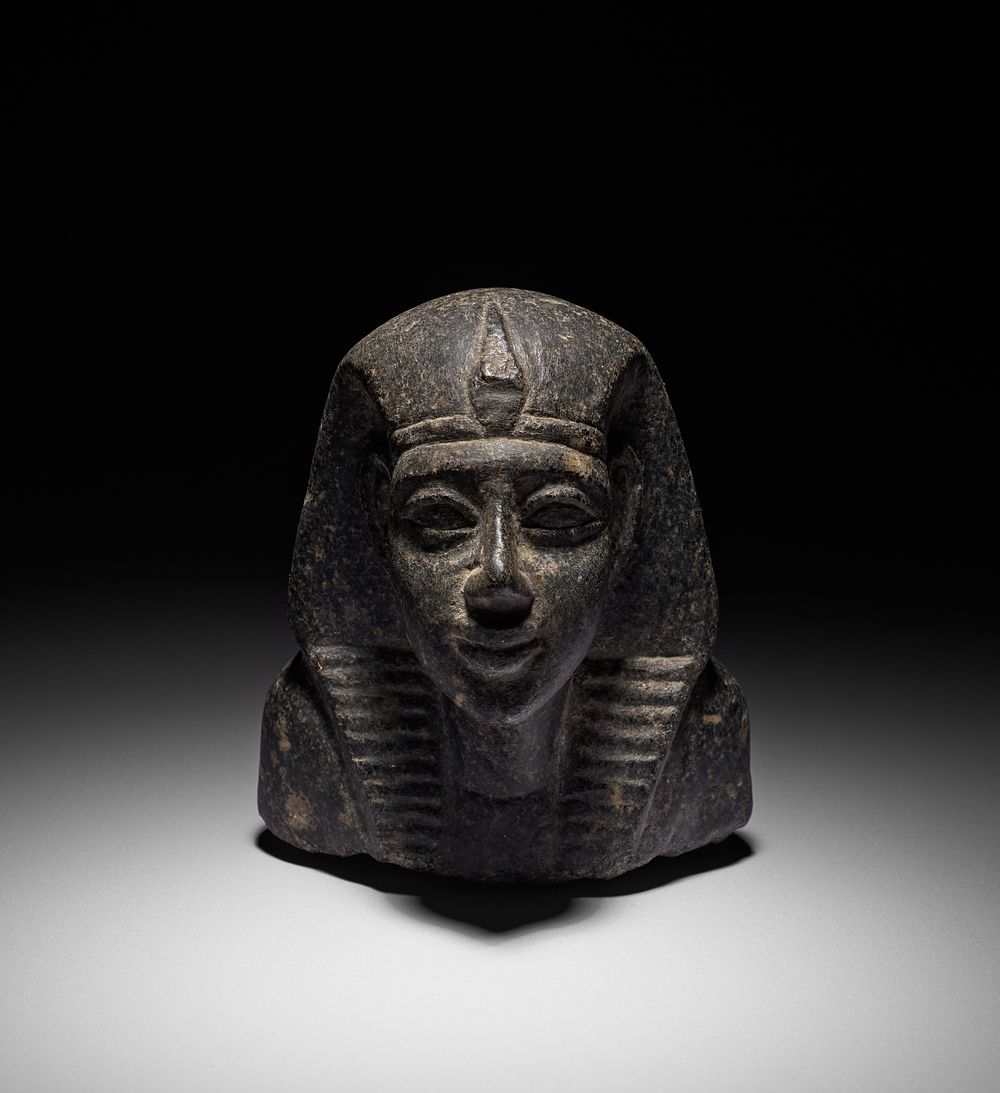 Lot 151: A CARVED BLACK STONE BUST, POSSIBLY ANCIENT EGYPT