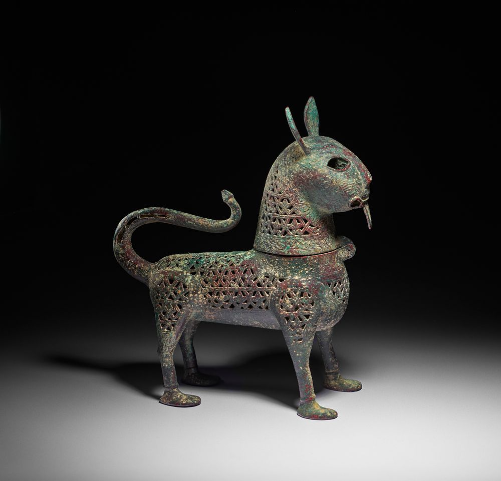 Lot 153: A RARE KHORASSAN ENGRAVED AND PIERCED BRONZE INCENSE BURNER IN THE FORM OF A LYNX, NORTH EAST IRAN, 12TH CENTURY