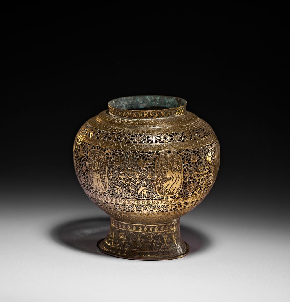 Lot 186: A QAJAR PIERCED BRASS VASE, PERSIA, 19TH CENTURY