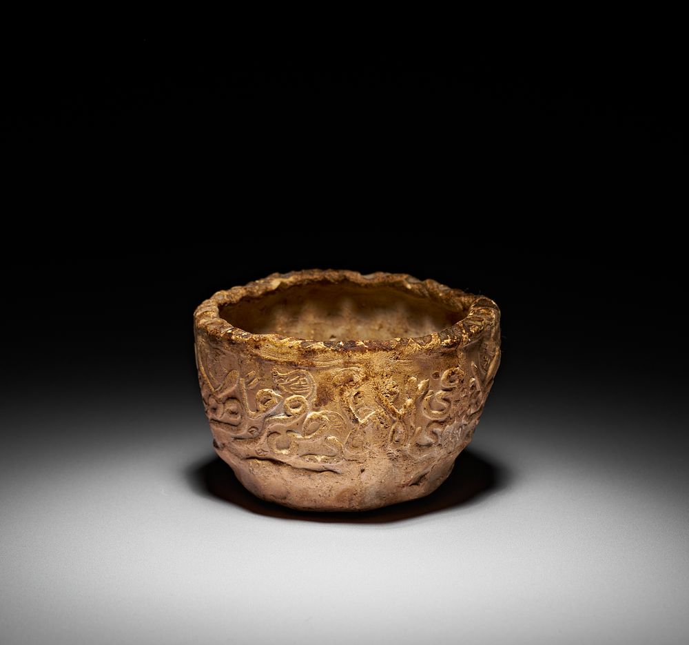 Lot 194: AN EARLY ISLAMIC SUN DRIED CLAY BOWL WITH CALLIGRAPHY, PROBABLY PERSIA