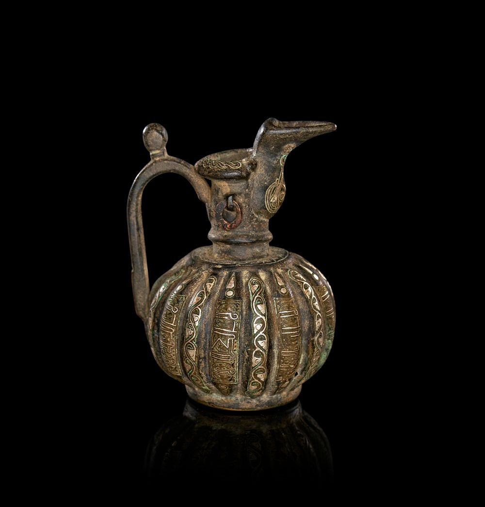 Lot 202: A SELJUK SILVER INLAID MINIATURE BRONZE EWER, KHURASAN, 12TH - 13TH CENTURY