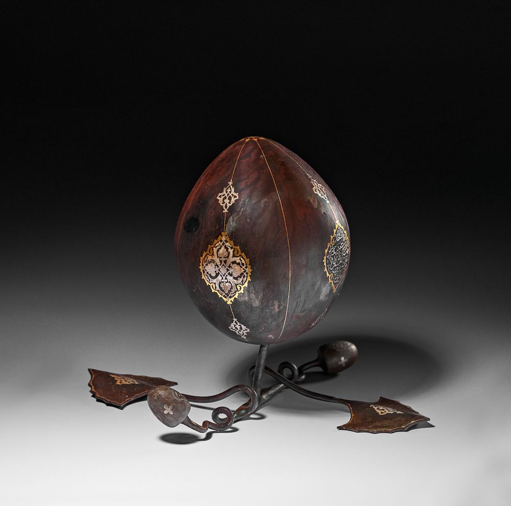 Lot 256: AN INSCRIBED GOLD-DAMASCENED STEEL MELON FRUIT, QAJAR IRAN, 19TH CENTURY