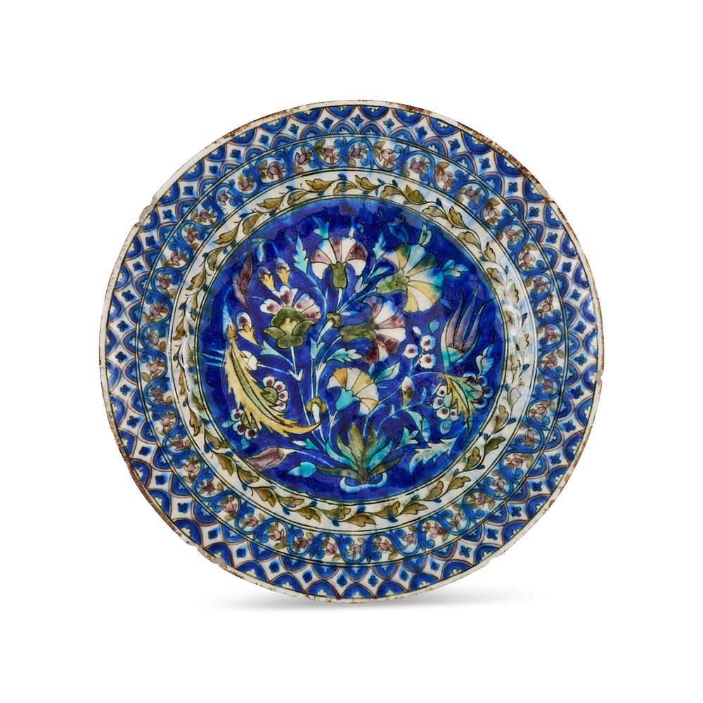Lot 282: A QAJAR UNDERGLAZE PAINTED POTTERY DISH, PERSIA, 19TH CENTURY