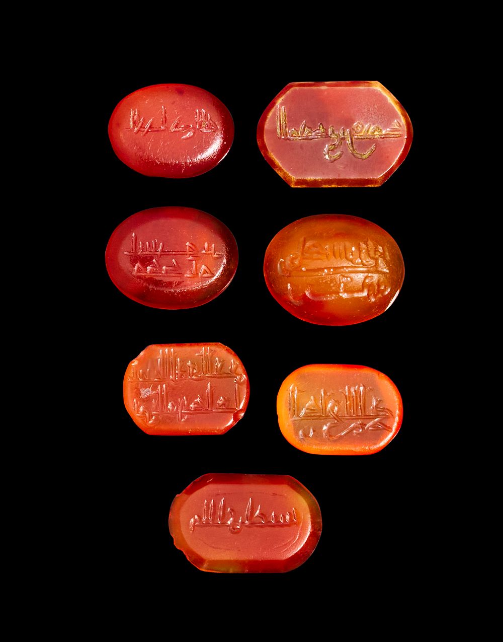 Lot 286: A GROUP OF SEVEN EARLY ISLAMIC ENGRAVED AGATE SEALS WITH KUFIC SCRIPT, 9TH - 12TH CENTURY