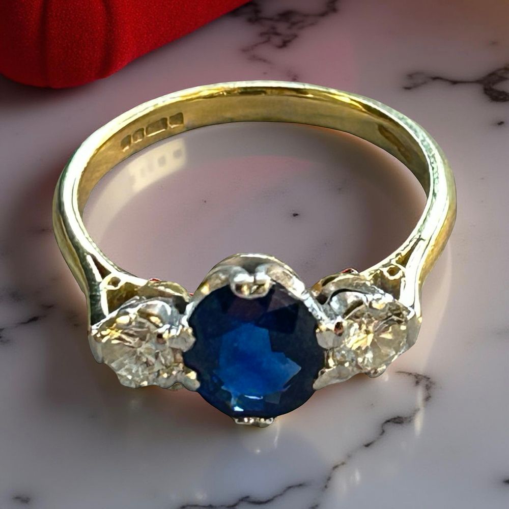 Lot 371: 18 ct gold sapphire and diamond trilogy ring