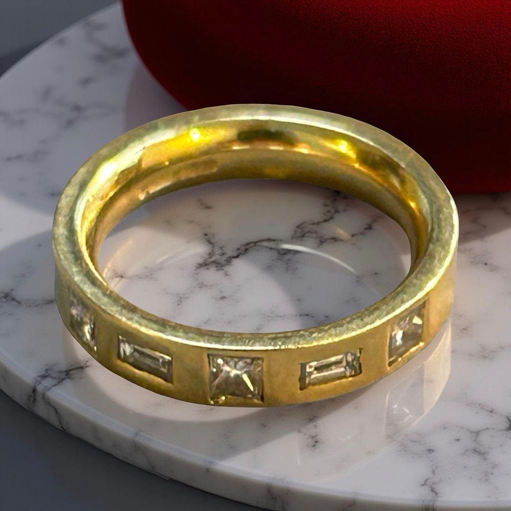 Lot 375: 18 ct gold and diamond band ring