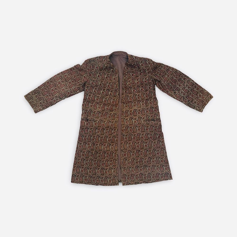 Lot 73: A ROYAL QAJAR WOVEN PAISLEY OPEN-FRONT JACKET/COAT, IRAN PROBABLY KERMAN, EARLY 20TH CENTURY