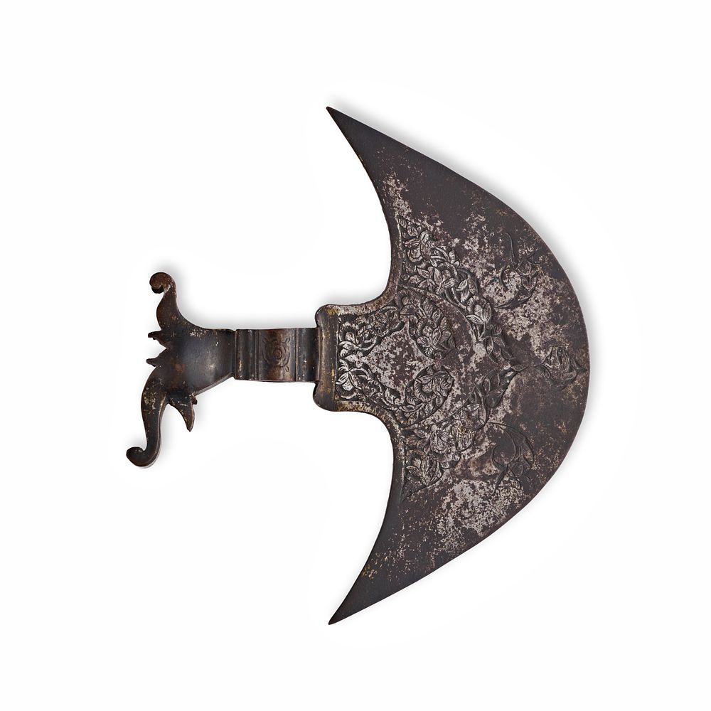 Lot 130: A QAJAR INDO-PERSIAN CHISELED STEEL TABARZIN AXE HEAD, 19TH CENTURY