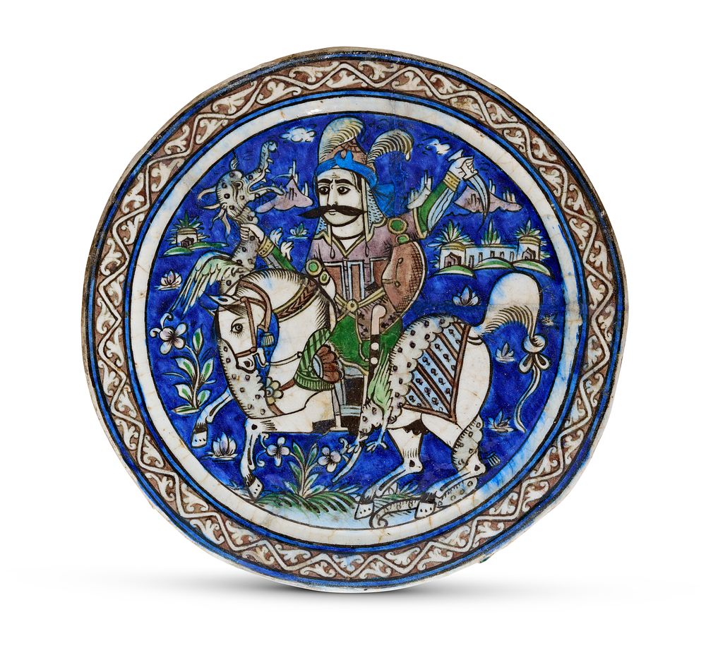 Lot 93: A QAJAR UNDERGLAZE-PAINTED MOLDED POTTERY TILE, PERSIA, 19TH CENTURY