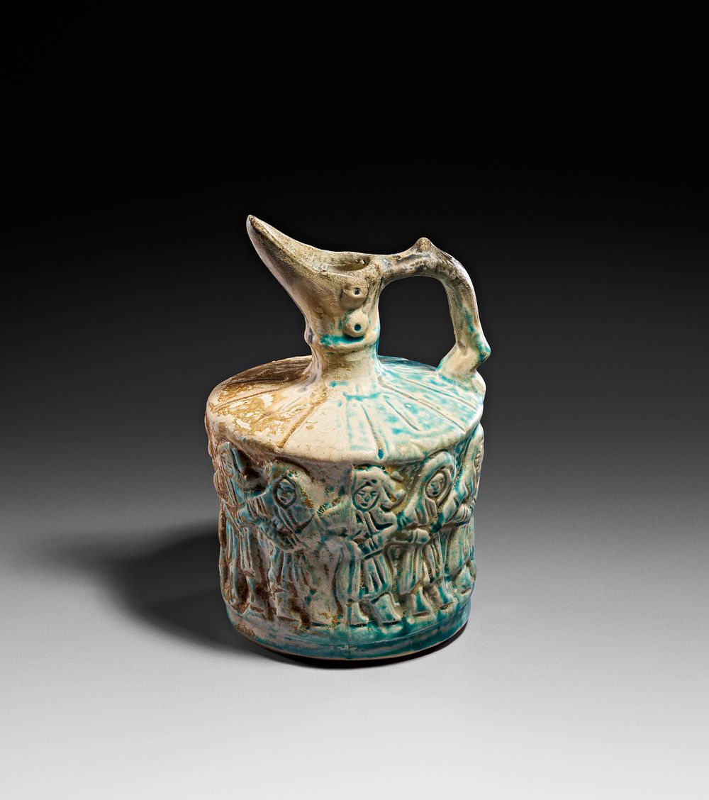 Lot 251: A KASHAN TURQUOISE-GLAZED FRITWARE CERAMIC DASTABAND DANCE EWER, PERSIA, 12TH CENTURY OR LATER