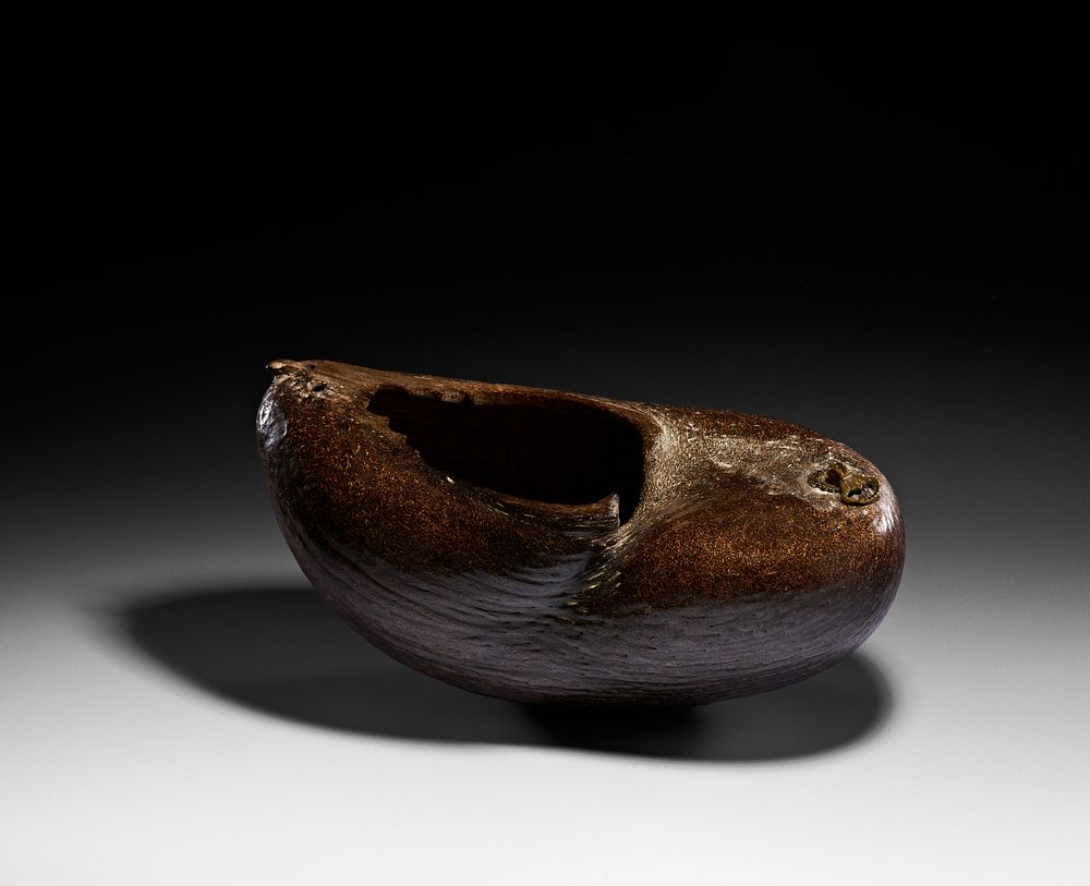 Lot 62: A QAJAR COCO-DE-MER BEGGAR'S BOWL (KASHKUL), IRAN, 19TH CENTURY