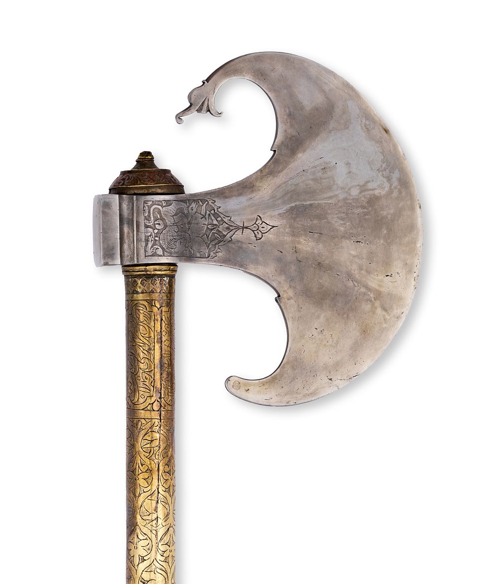 Lot 129: A PERSIAN QAJAR CHISELLED STEEL AXE WITH ENGRAVED BRASS SHAFT, 19TH CENTURY