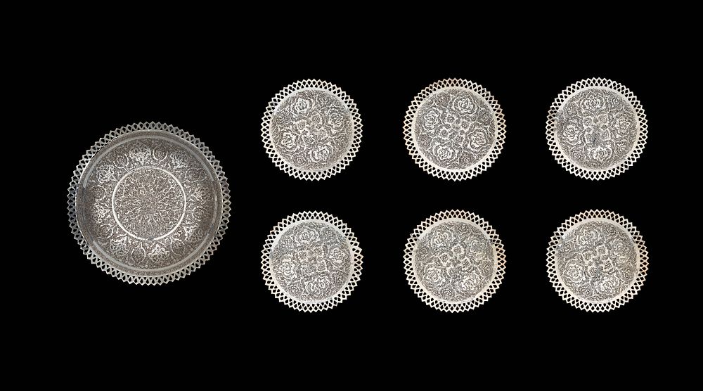 Lot 259: A SET OF MIDDLE EASTERN STYLE ENGRAVED SILVERED TABLEWARE, 20TH CENTURY
