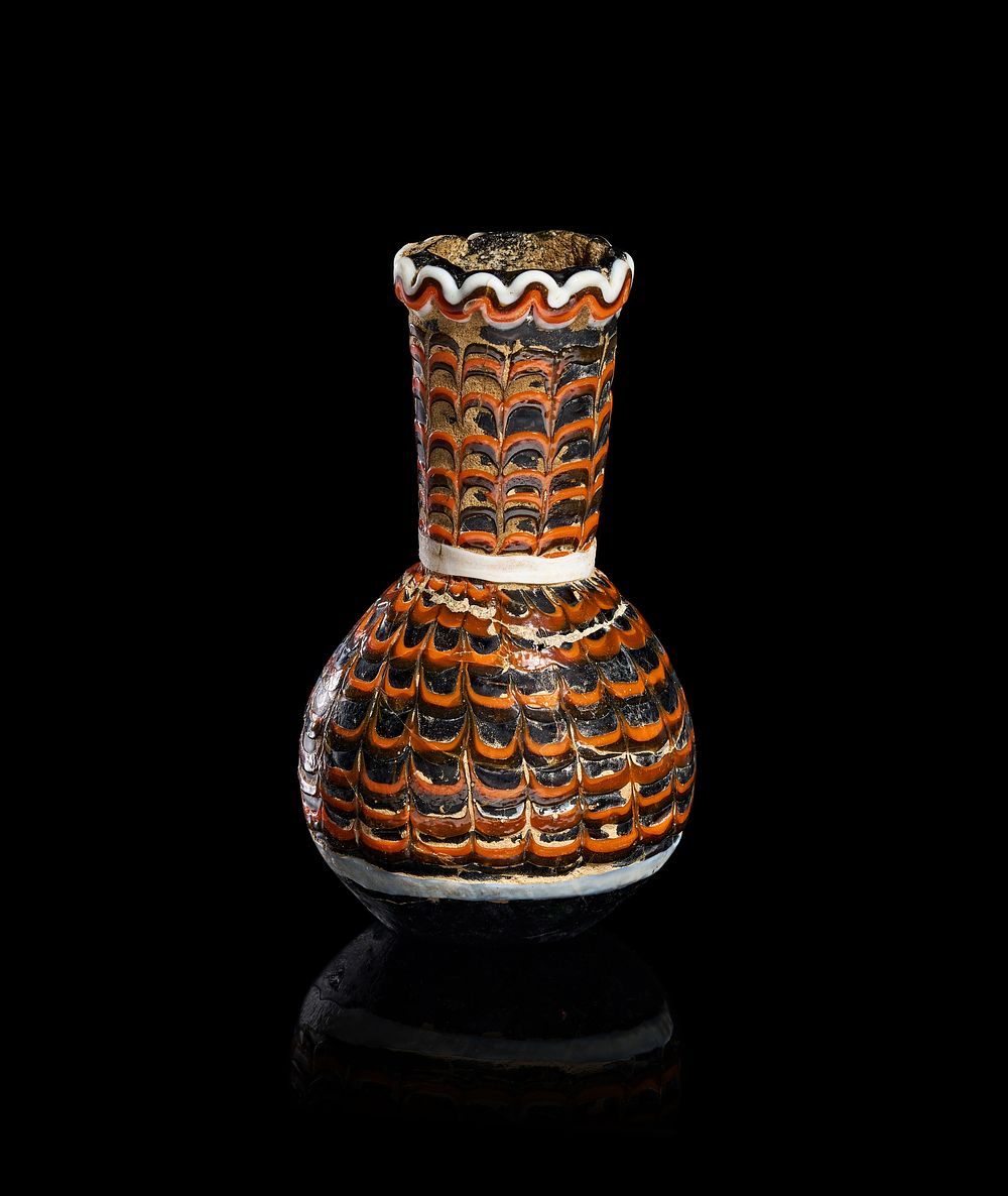 Lot 336: AN ANCIENT ABBASID CORE-FORMED GLASS AMPHORISKOS VASE, IRAQ, POSSIBLY 9TH CENTURY