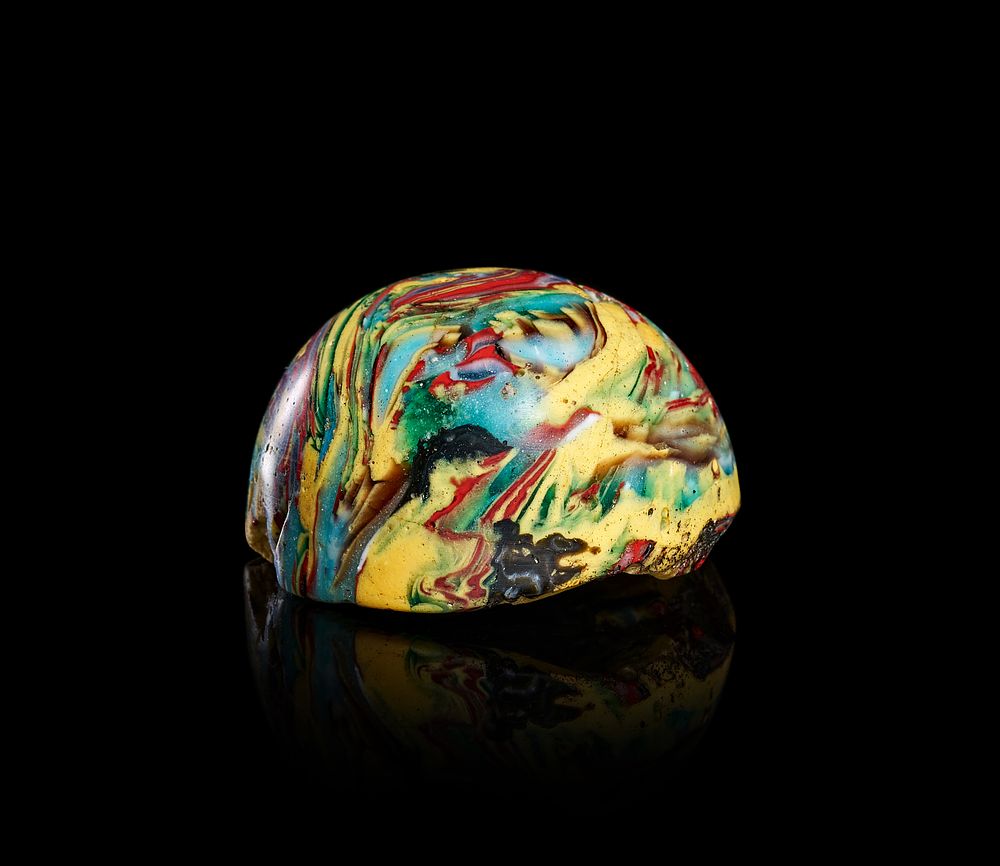 Lot 271: A LARGE ABBASID MOSAIC POLYCHROME MARBLED GLASS GAME PIECE, 9TH CENTURY OR LATER